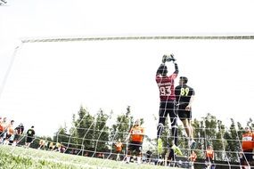 football players jump in goal