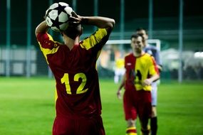 football player throws the ball onto the field
