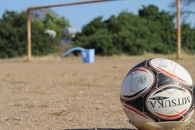 soccer ball in the sand close up