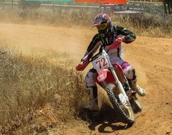motorcycle on a bend in deep sand at a motorcycle race
