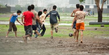 muddy children playing football