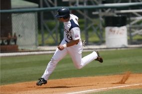 baseball player runs along the field