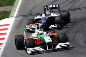 two race cars on a track in India