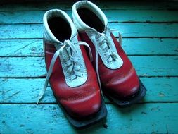 vintage Red Ski Boots on Blue wooden floor