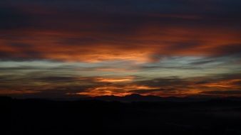 morning sun in a veil of dark clouds