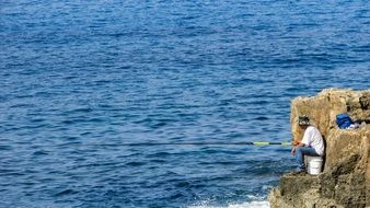 fisherman on the rock