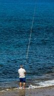 fisherman with long fishing rod