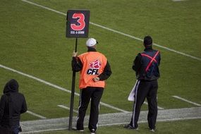 judges on the edge of the field in football
