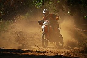 motorcycle racer on a dusty track on a sunny day