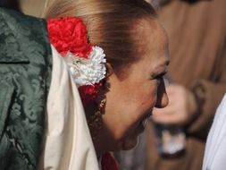 woman with a carnation on her head