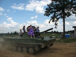 people are sitting on the tank on victory day