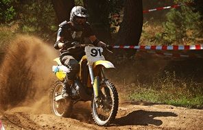 motorcycle race among the dust on a sunny day