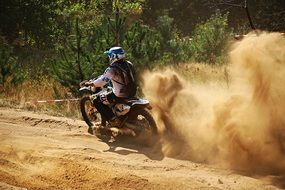 motorcycle racing in the sand in the sun