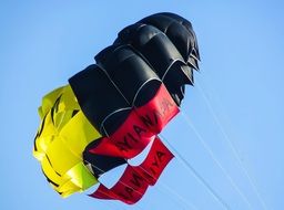 Colorful parachute for paragliding in a clear blue sky