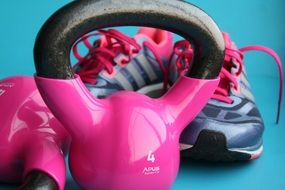 pink dumbbells and women's sports sneakers