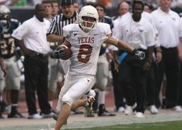 running ball player in american football