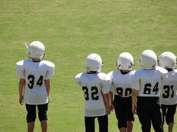 american Football players standing on field