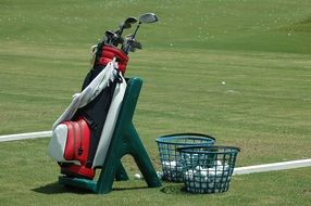 golf bag stands on a green field