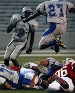 American football players jumping during a match