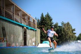 wakeboarding, young man on surf holding rope