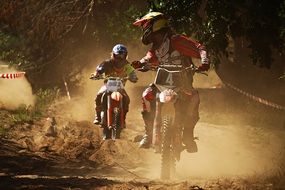 Motorcycle sport on a dusty track on a sunny day