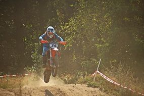 Motorcycle sport in the dust on a sunny day
