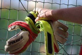 goalkeeper gloves in hand