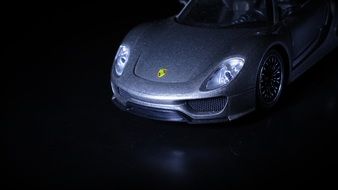 front view of a Porsche car in the dark