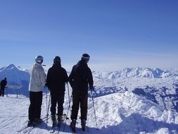 three skiers on a mountain in switzerland