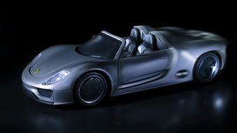 luxurious silver porsche in the dark