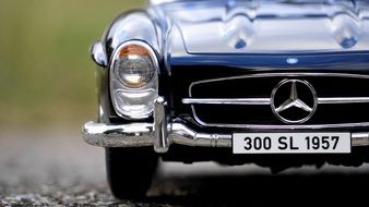 front view of a black 1950s Mercedes in a miniature on the pavement