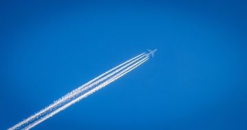 White trails of the airplane in blue sky