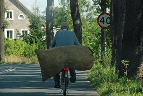 man with a bag on a bicycle