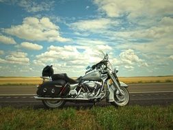 harley davidson Motorcycle stands on Road under Blue Sky