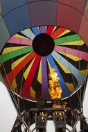 Colorful flying hot air balloon with the flame