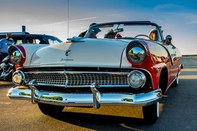 front of an old car parked