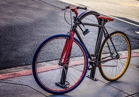 colored bike on the sidewalk