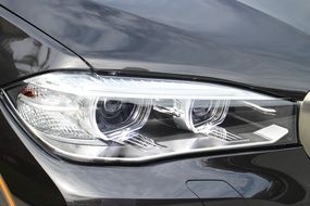 headlight of a black luxury car close-up
