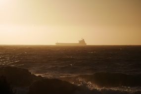 cargo ship in the ocean on a background of fog