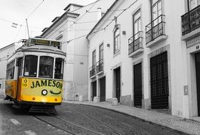 Black and white photo with the colorful tram in Lisbon