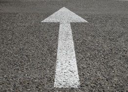 white arrow painted on the road
