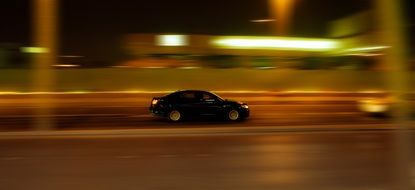 car in motion on the street at night