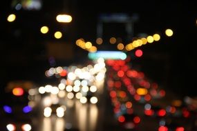 Night glare of light cars on the street