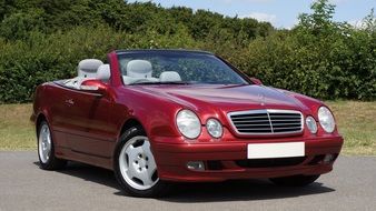 Parked red luxury Mercedes-Benz under the bright Sun