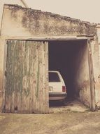 the car is in a wooden garage