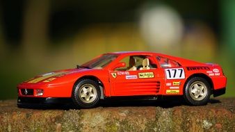 red racing car in miniature on the table