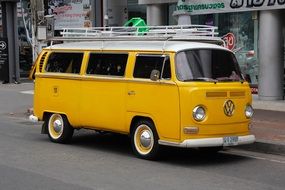 yellow travel bus stands on the road