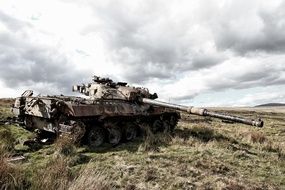 A military tank is standing in the field