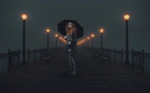 girl under an umbrella on a night city street