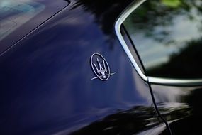 Logo of Maserati on the car